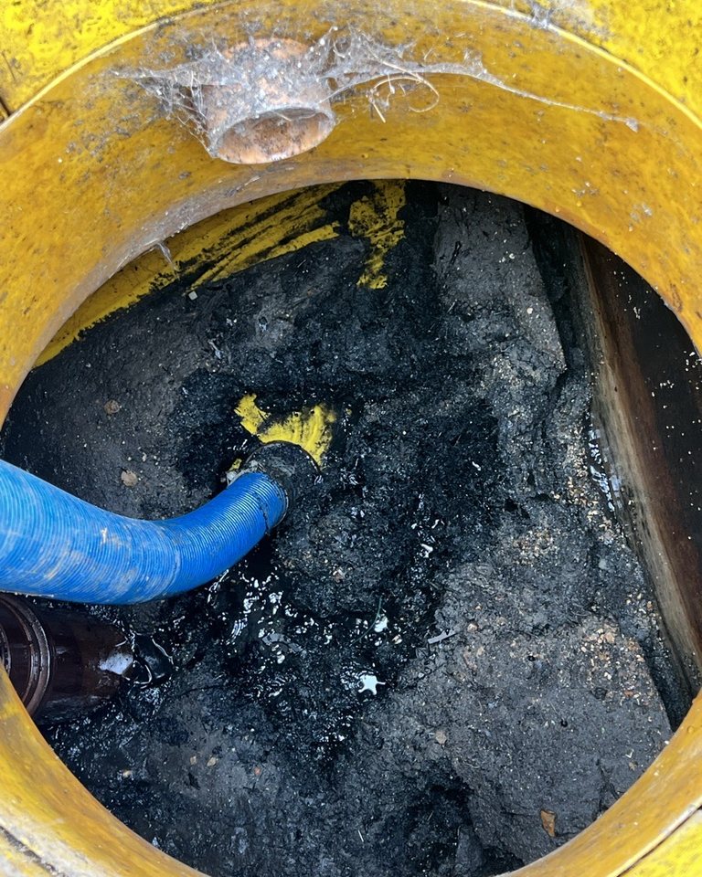 Drainage access chamber containing accumulated material before investigation