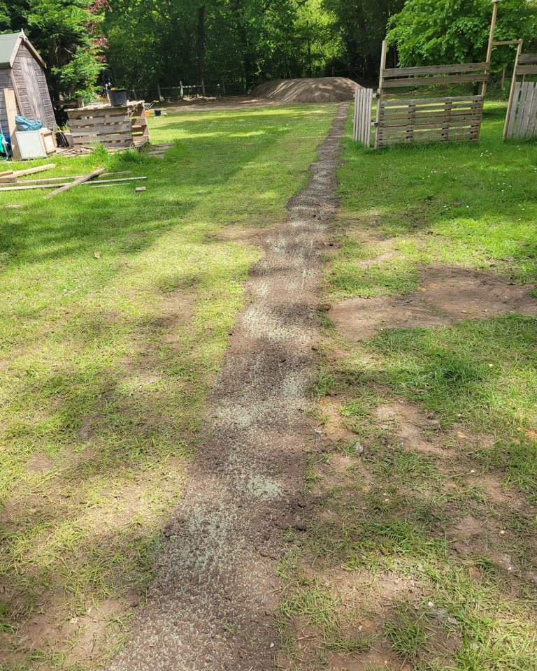 Backfilled drainage route crossing grassed ground